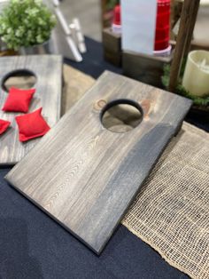 a wooden cutting board sitting on top of a table next to candles and other items