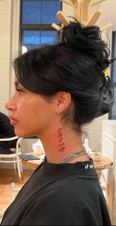 a woman with a tattoo on her neck