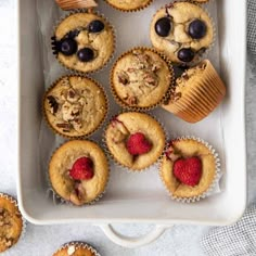 muffins with chocolate chips and raspberries in a white tray