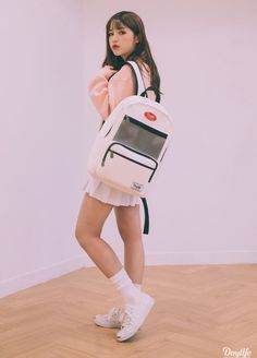 a young woman is carrying a white backpack