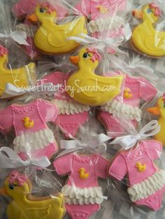 decorated cookies in the shape of ducks and sweaters for baby shower party or first birthday