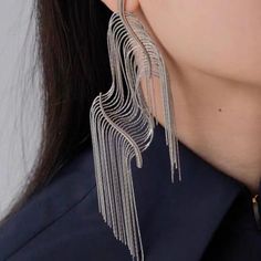 Introducing our Squiggly Line Silver Tassel Earrings – where art meets fashion for a bold and luxurious style statement! 🎨 **Artistic Innovation** 🎨These earrings are more than jewelry; they're wearable masterpieces. Crafted with hyper-realistic squiggly lines and bold contours, they mimic the look of cut and flexible edges, creating a unique work of art. ✨ **Silver Elegance** ✨Rhodium plated. They combine durability with a captivating shine. The silver tassel fringe adds movement, making them Metal Tassel Earrings For Party, Trendy Chandelier Earrings For Evening, Long Drop Tassel Earrings For Party, Long Drop Metal Tassel Earrings For Party, Elegant Fringe Metal Chandelier Earrings, Trendy Fringe Metal Jewelry, Fringe Dangle Metal Earrings, Metal Fringe Dangle Earrings, Silver Fringe Metal Earrings