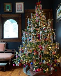 a decorated christmas tree in the corner of a room