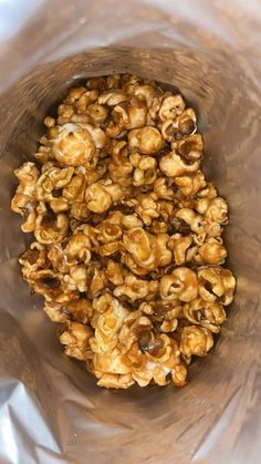 a glass bowl filled with nuts on top of a table