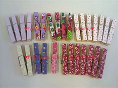 many different types of clothes pins are arranged on a table with red and white polka dots