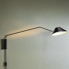 a black wall lamp with a white light on it