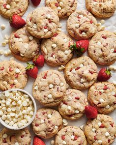 strawberries and white chocolate chip cookies on a table