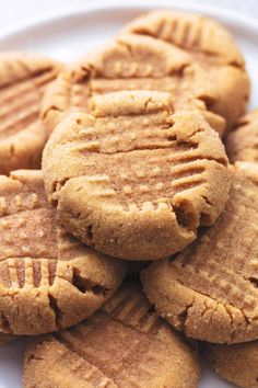 peanut butter cookies stacked on top of each other in a white plate with text overlay