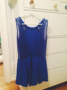 a blue dress hanging on a white hanger