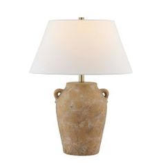 a lamp that is on top of a table with a white shade over the base