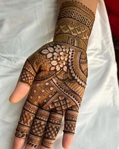 the hand is decorated with intricate designs