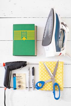 a pair of scissors, an iron, and other items laid out on a table