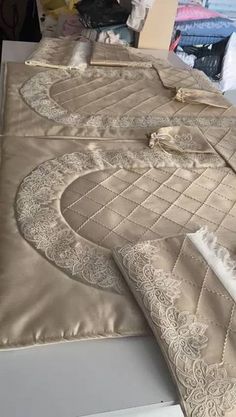 the bed is covered with an elaborately designed comforter