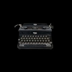 an old fashioned typewriter on a black background