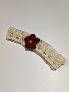 This hand knit baby headband was made with softness and comfort in mind. It is embellished with a small white pearl to add to the intricacy of the knitting pattern. Size: - Head size 17 inches (circumference) Fabric & Care: - 100% Merino Wool (Super-wash) - Use detergent for fine wash without softener Questions? - Feel free to reach out and we'll get back to you as soon as possible. Handmade Yarn Headband As Gift, Handmade White Headband, Handmade One Size Headband For Gift, Handmade Cream Headband, Handmade White Headband Hair Accessory, Handmade Cream Hair Headband, Handmade Adjustable Cream Hair Accessories, Handmade Headband Gift, White Handmade Headband