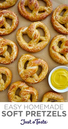 pretzels and mustard are sitting on a baking sheet with the pretzels ready to be baked