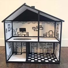 a doll house made out of cardboard with furniture and accessories on the inside, sitting on top of a hard wood floor