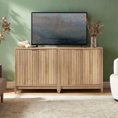 a television sitting on top of a wooden cabinet