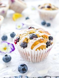 blueberry muffins with icing and fresh berries