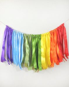 a rainbow streamer hanging on a white wall