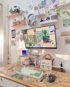 a flat screen tv sitting on top of a wooden table next to a keyboard and mouse