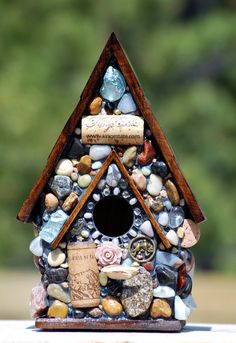 a bird house made out of rocks and stones