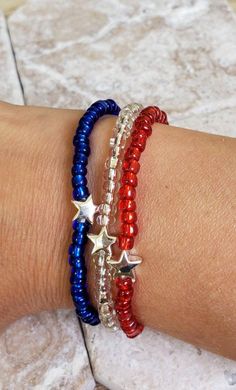 This set of 3 bracelets includes a red, clear/white, and blue bracelet. Each have a silver hematite star at the center for a simple patriotic look. Wear together or separately. On elastic cording for ease of wear. Customized to fit you. Makes a great military support gift for a military mom, wife, sister, you name it! 🤍 You will receive 3 bracelets, one of each color. 🤍 Please measure your wrist and choose your size from the drop-down menu at checkout, sizing up a half inch for a looser fit, i Fourth Of July Bracelets, Patriotic Red Beaded Bracelets As Gift, 4th Of July Bracelets, Red White And Blue Bracelets, 4th July Braclets, Handmade Patriotic White Bracelet, Patriotic Handmade Bracelet Jewelry, Patriotic Red Beaded Bracelets, Stretch Beaded Bracelets Diy