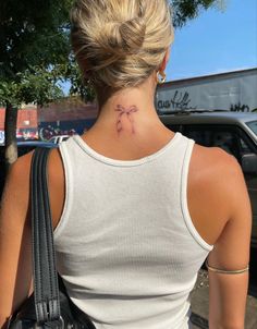 a woman with a tattoo on her neck