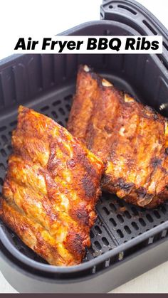 two pieces of grilled meat sitting on top of an air fryer basket with text overlay that says, air fryer ribs