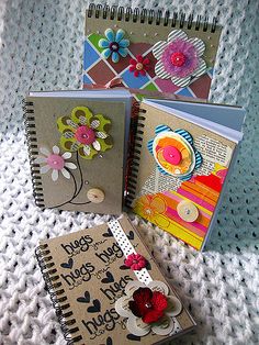 three small notebooks with different designs on them