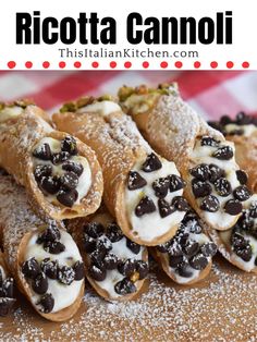 there are chocolate covered crepes with white cream and black olives on them