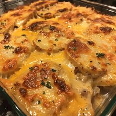 a cheesy casserole dish with potatoes and meat