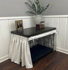 a dog crate with a table and pictures on it