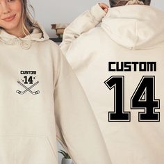 "Elevate your game day look with our Custom Hockey Sweatshirt! Ideal for the devoted hockey mom, this cozy hoodie is a thoughtful Mother's Day gift. Show off your team pride in comfort and style. Order now to make her feel appreciated on her special day!" Welcome to VickyTeeDesign Shop! How to Order  * Please choose your t-shirt color and the shirt size by the drop-down menus * Enter the design idea or the personalization if you would like. * Please feel free to ask any questions. My Shirt Mater Hockey Hoodie Ideas, Casual Customizable Hoodie For Sports Events, Sports Fan Team Name Hoodie For Winter, Sports Fan Winter Hoodie With Team Name, Sports Fan Team Name Winter Hoodie, Customizable Winter Sweatshirt For Sports Events, Customizable Team Spirit Sweatshirt For Winter, White Team Logo Hoodie For Game Day, Customizable Casual Sports Hoodie