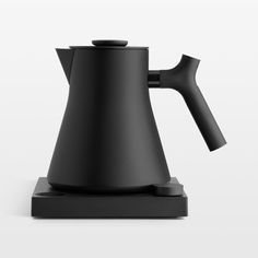 a black coffee pot sitting on top of a stand