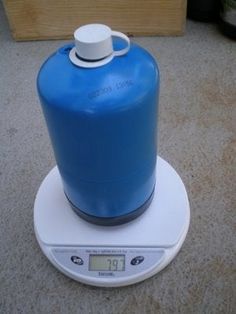 a blue jug sitting on top of a scale