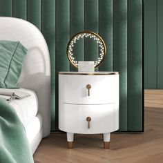 a white nightstand sitting next to a bed in a room with green walls and wooden floors