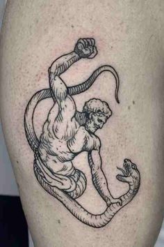 a man with a snake tattoo on his leg is shown in black and grey ink