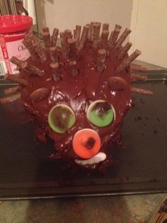 a cake shaped like a hedgehog with green eyes