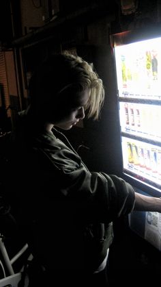 a person standing in front of a vending machine