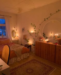 a bed room with a neatly made bed next to a window and candles on the nightstands