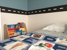 a bed with a quilt on top of it and a book shelf in the corner