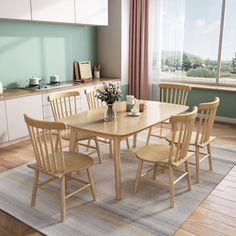 a dining room table and chairs in front of an open window with the view outside