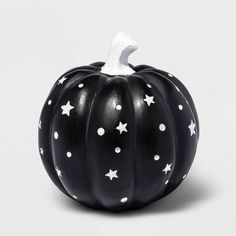 a black pumpkin with white stars painted on it