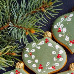 three decorated christmas cookies sitting on top of a table