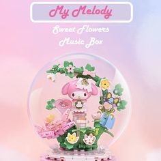 an image of a snow globe with hello kitty in the center and flowers around it