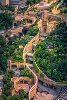 an aerial view of a curved road surrounded by trees