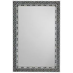 a mirror that is sitting on top of a white surface with an intricate border around it