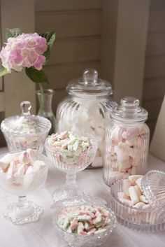 a table topped with glass containers filled with candy