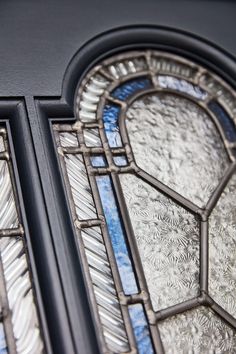 an old stained glass window with blue and white designs